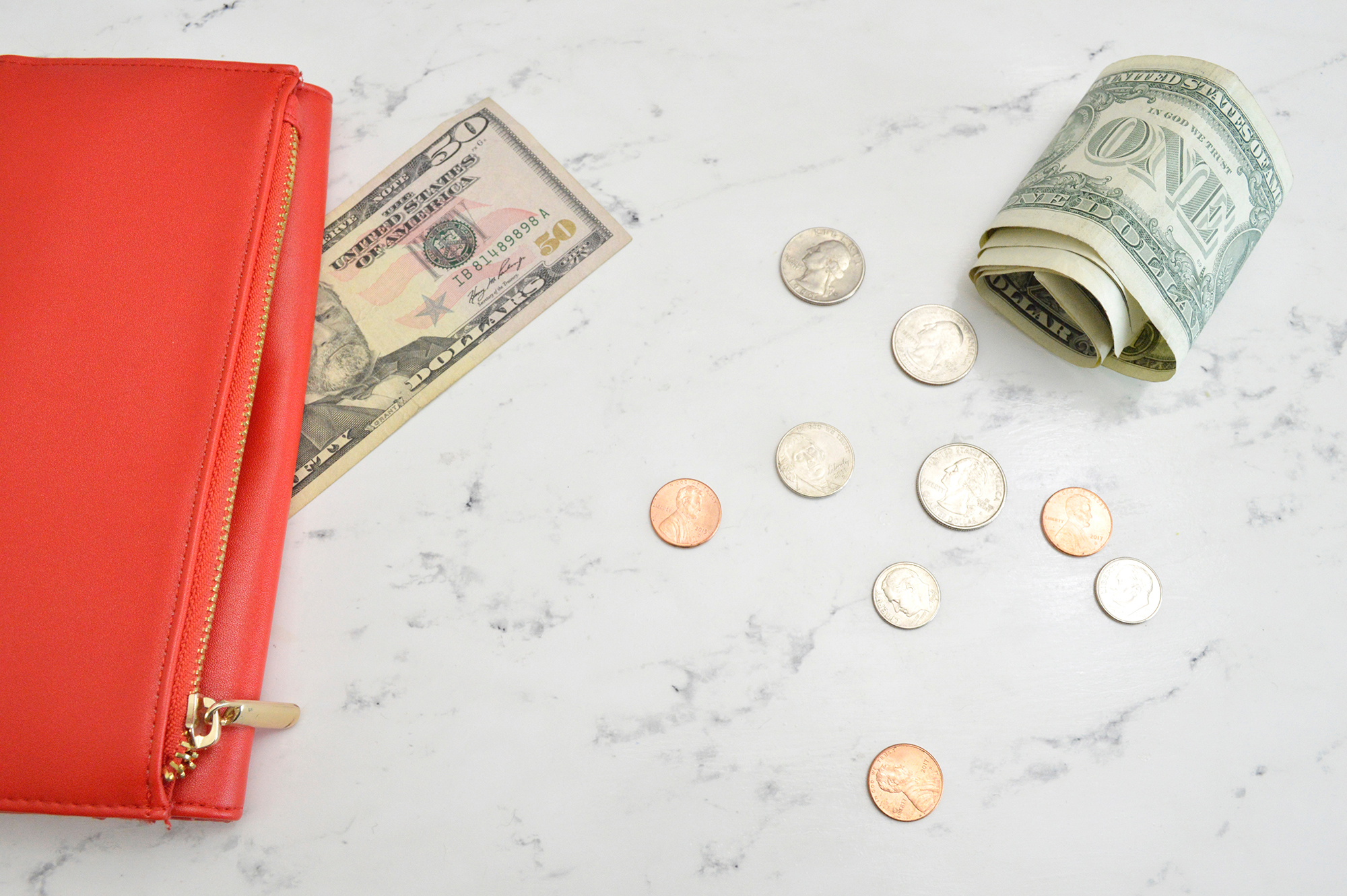 A wallet with spilled change and cash