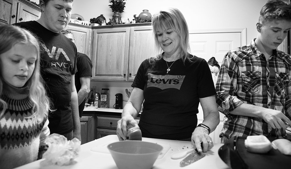 Student in the kitchen with her family