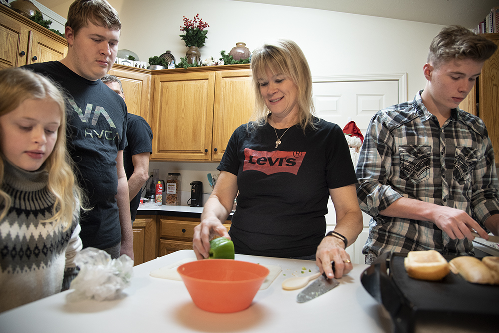 Student in the kitchen with her family