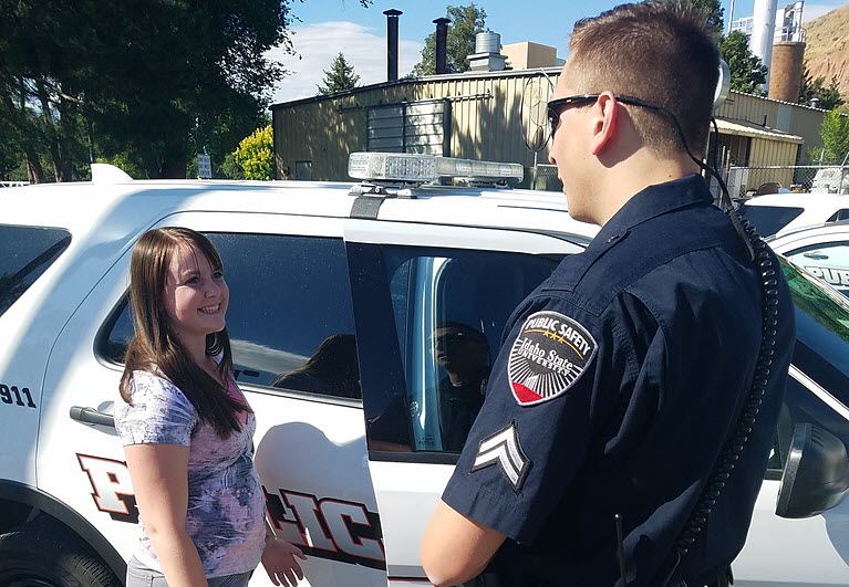 A public safety officer talking to a student