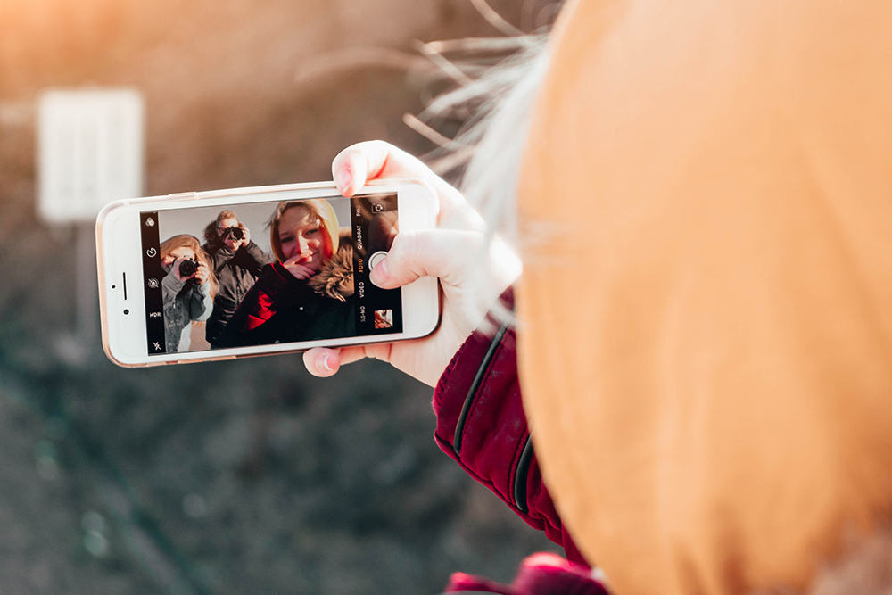 A student taking a picture with her phone