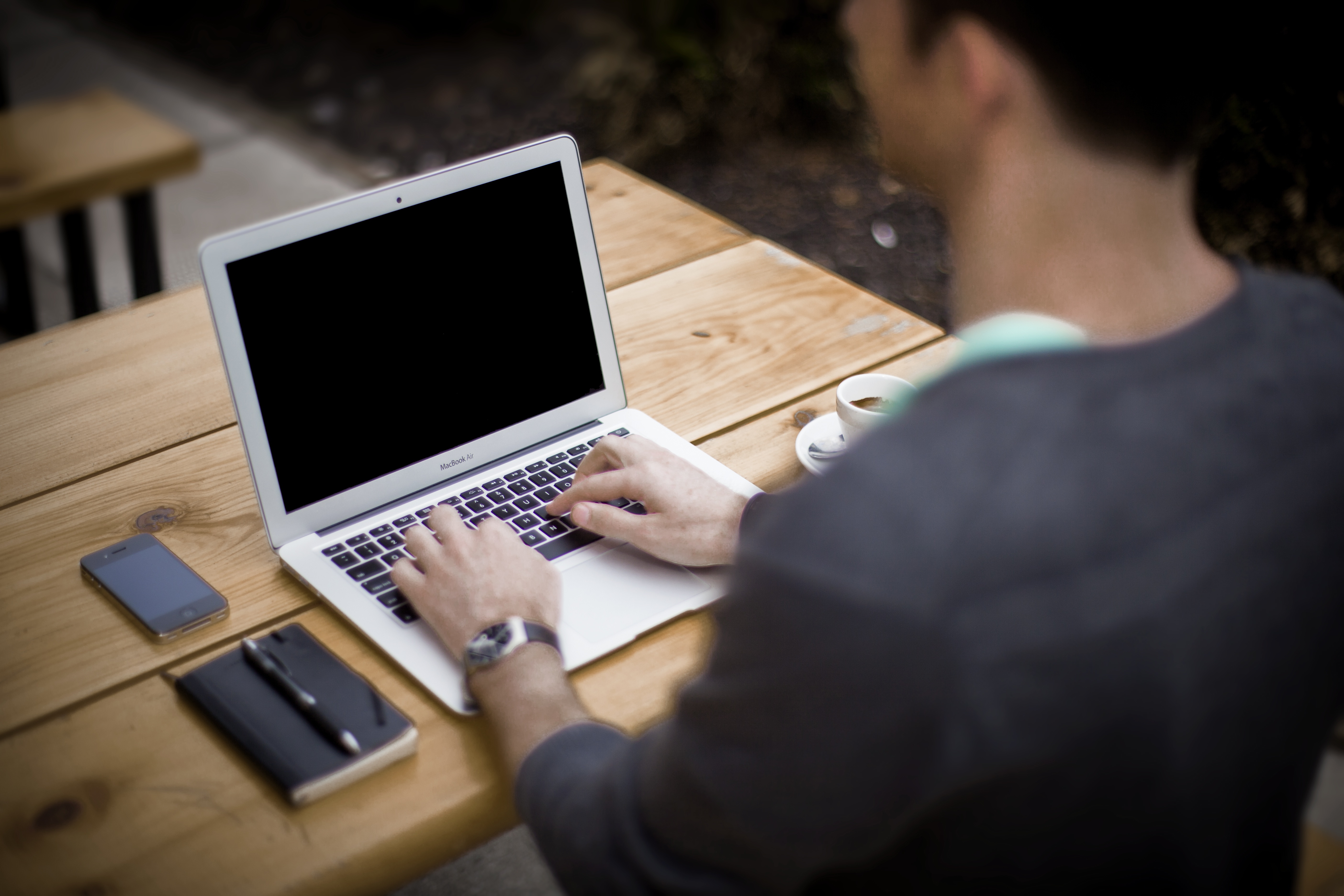 A student typing on their laptop