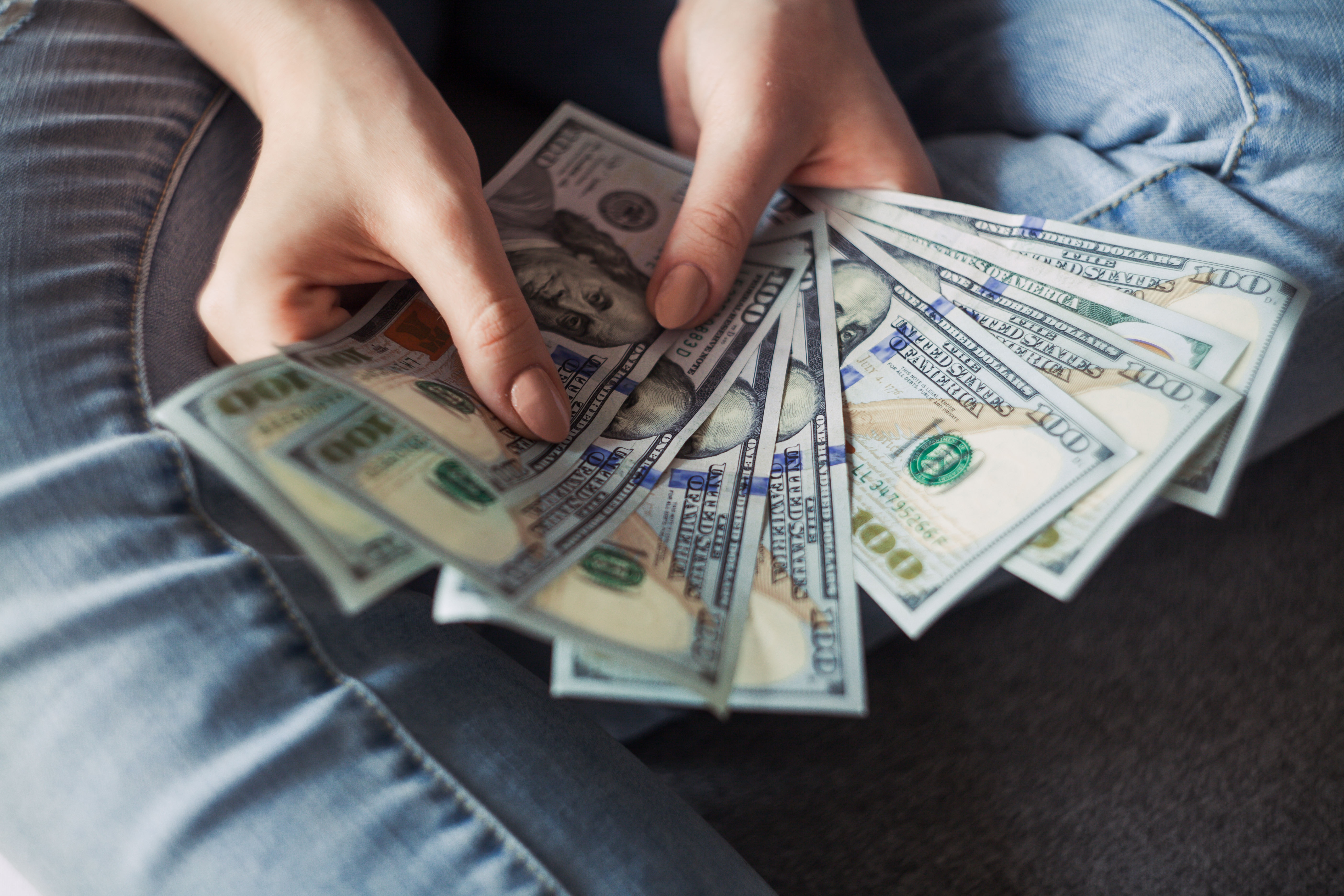 A person counting a stack of money