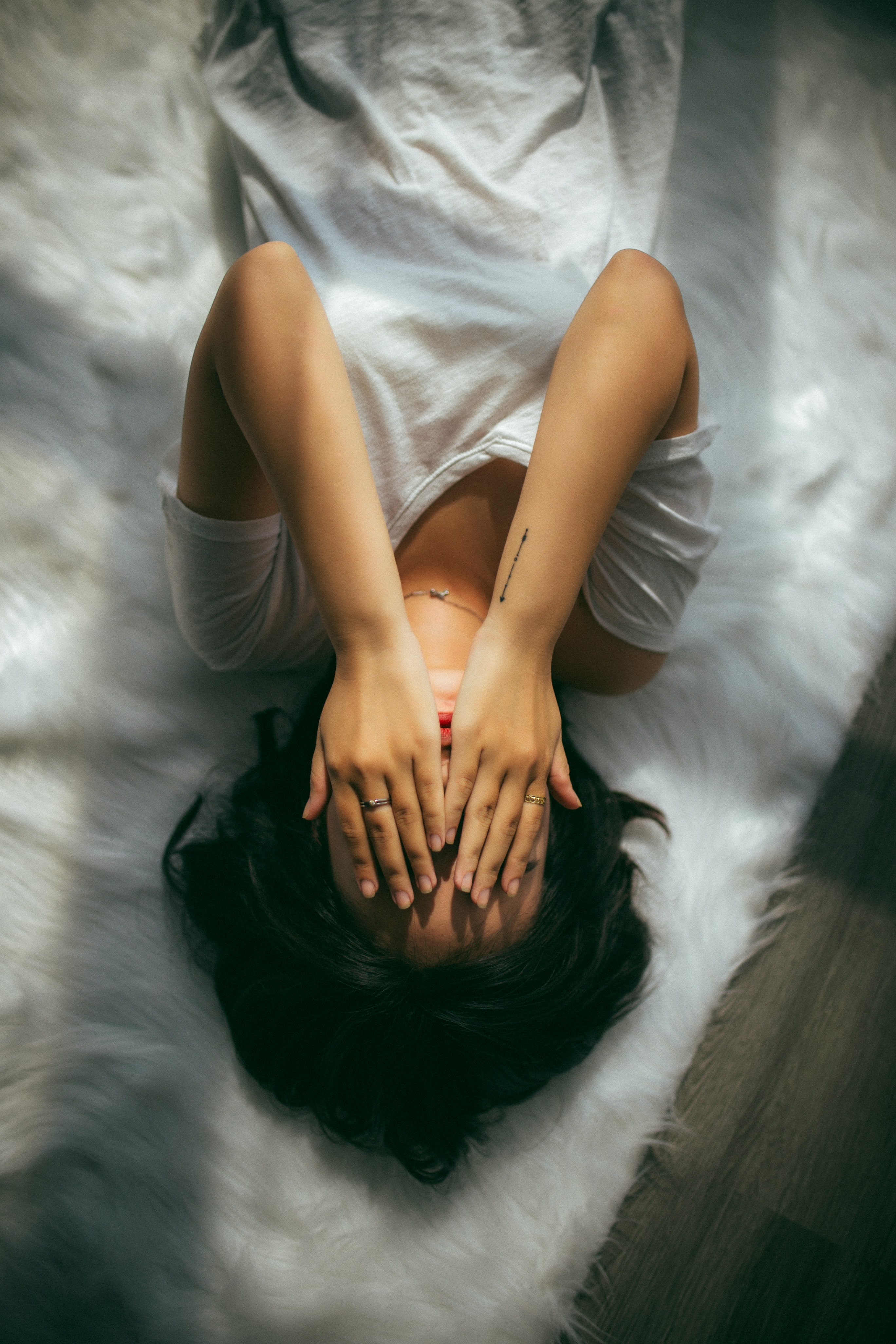 A student laying down covering her face