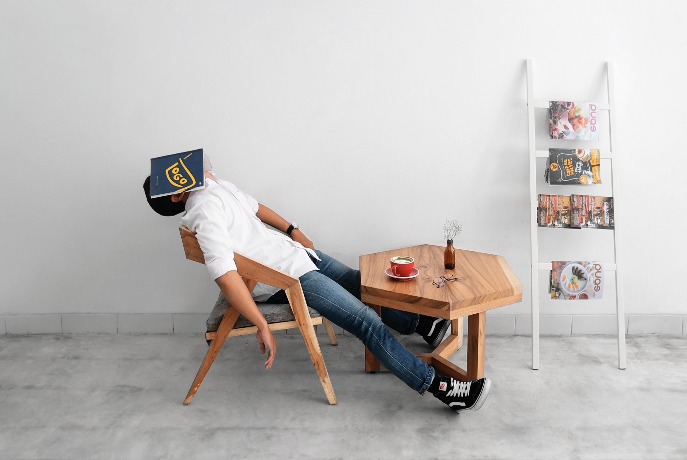 Student laying in a chair with their face covered