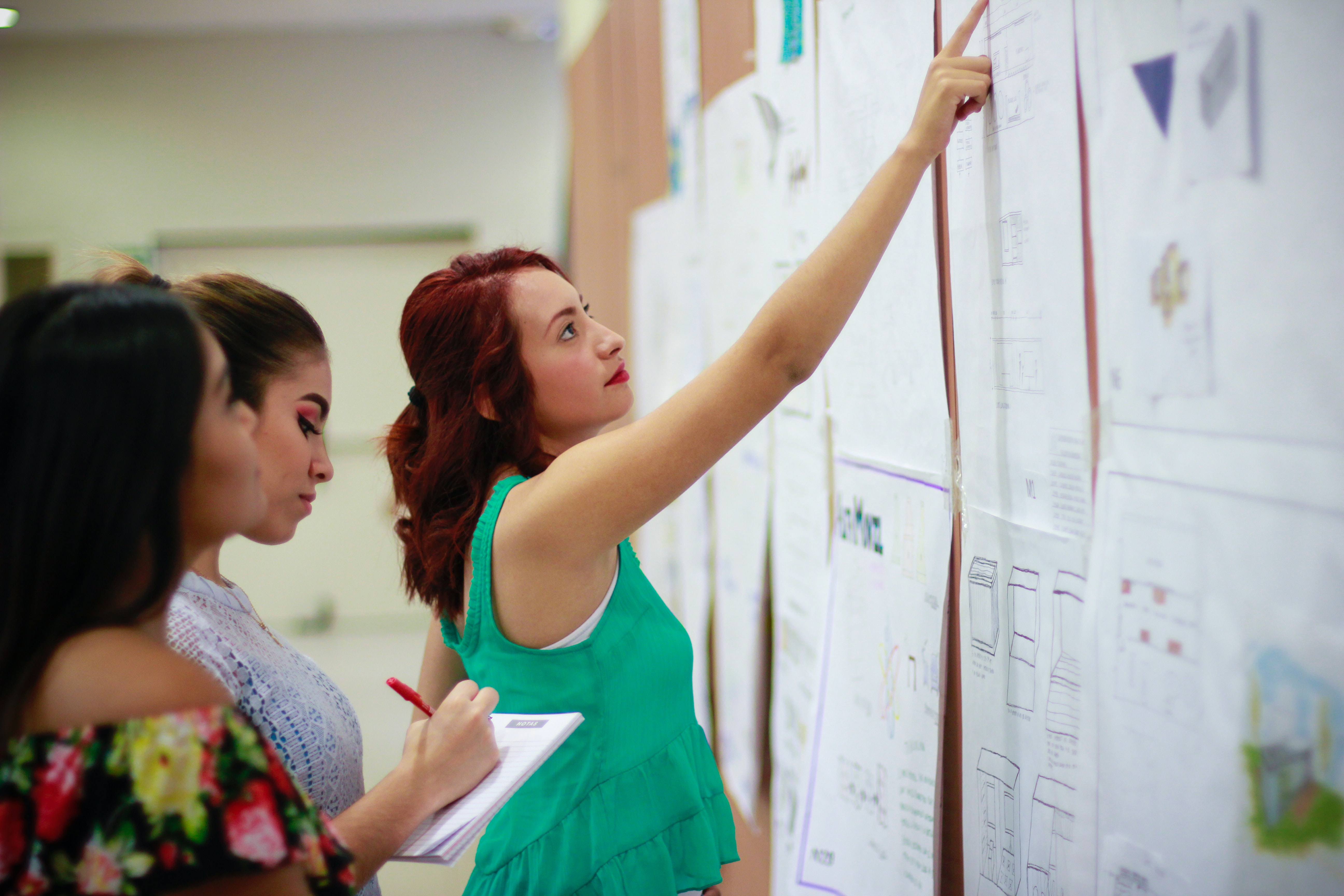 Students putting papers on a wall