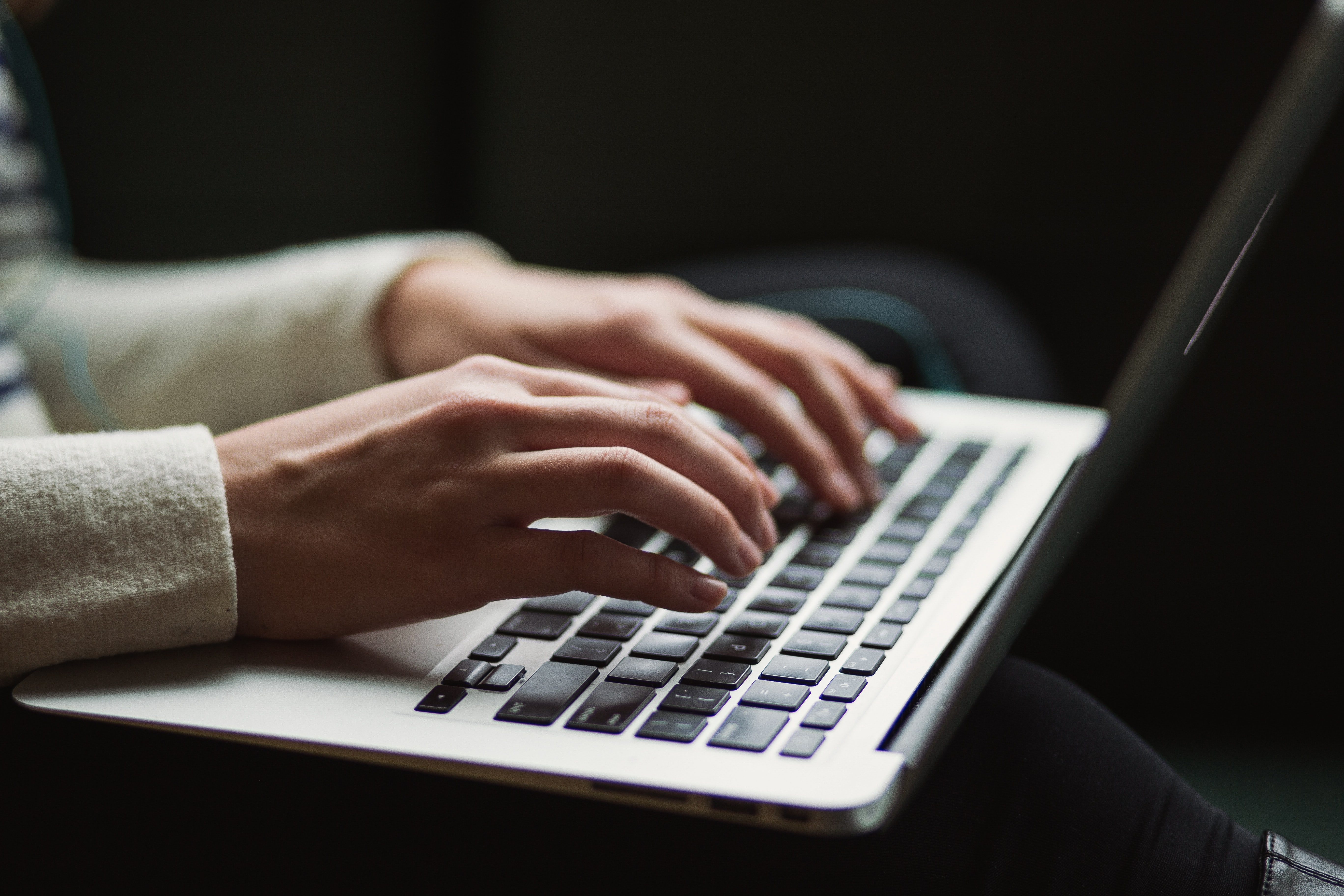 A student typing on their laptop