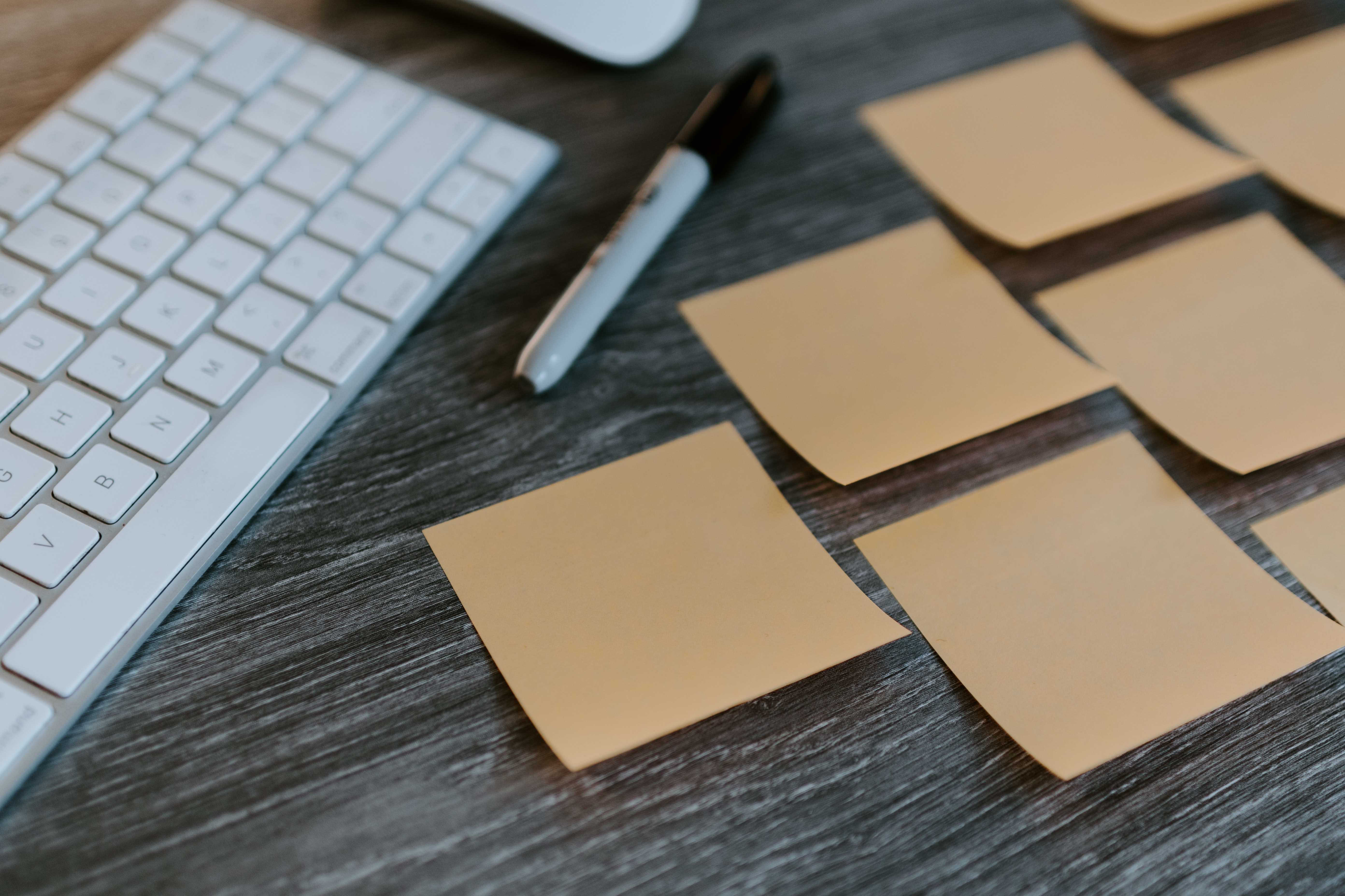 Organization of sticky notes, a keyboard, and a marker