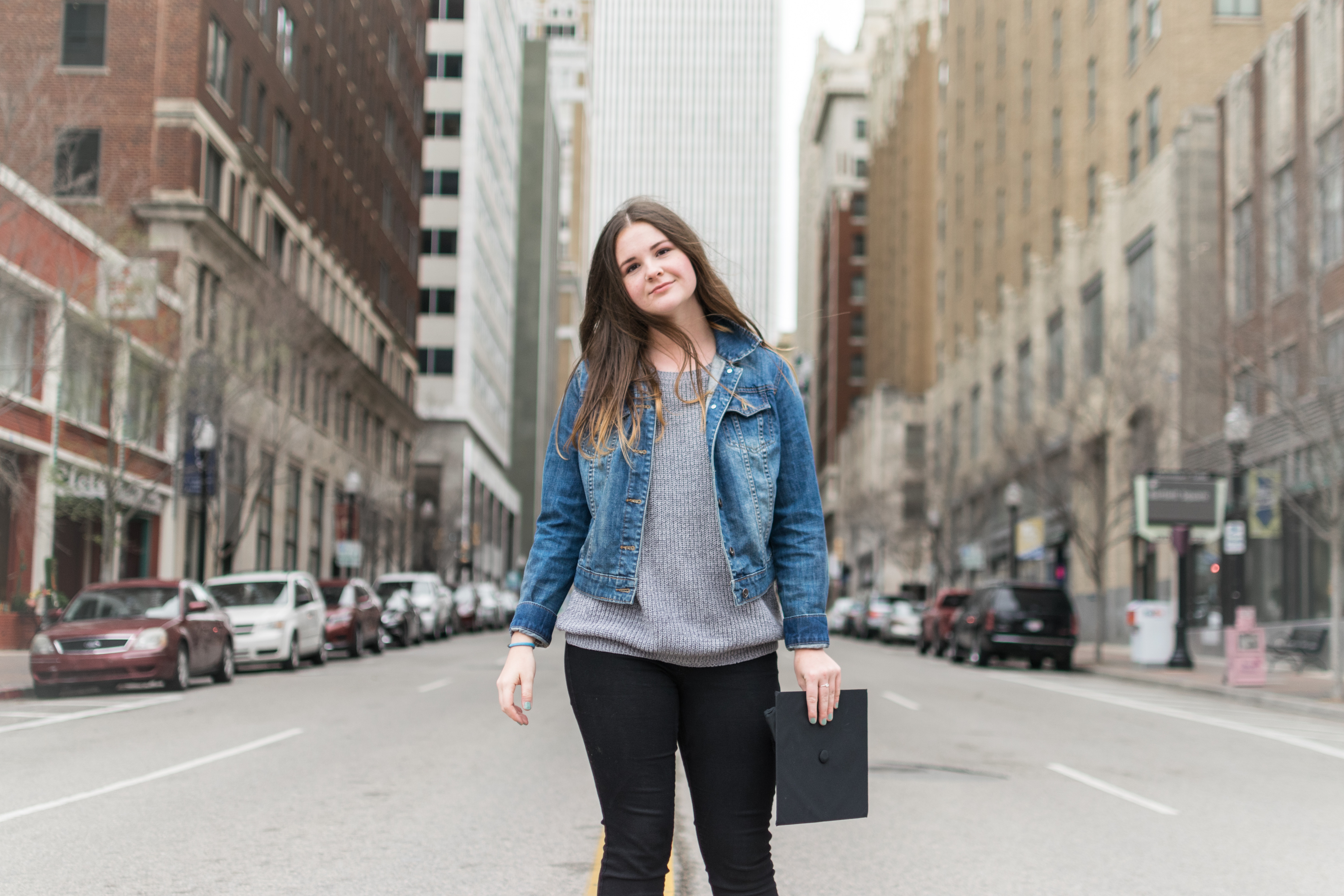 A woman standing in the middle of a street