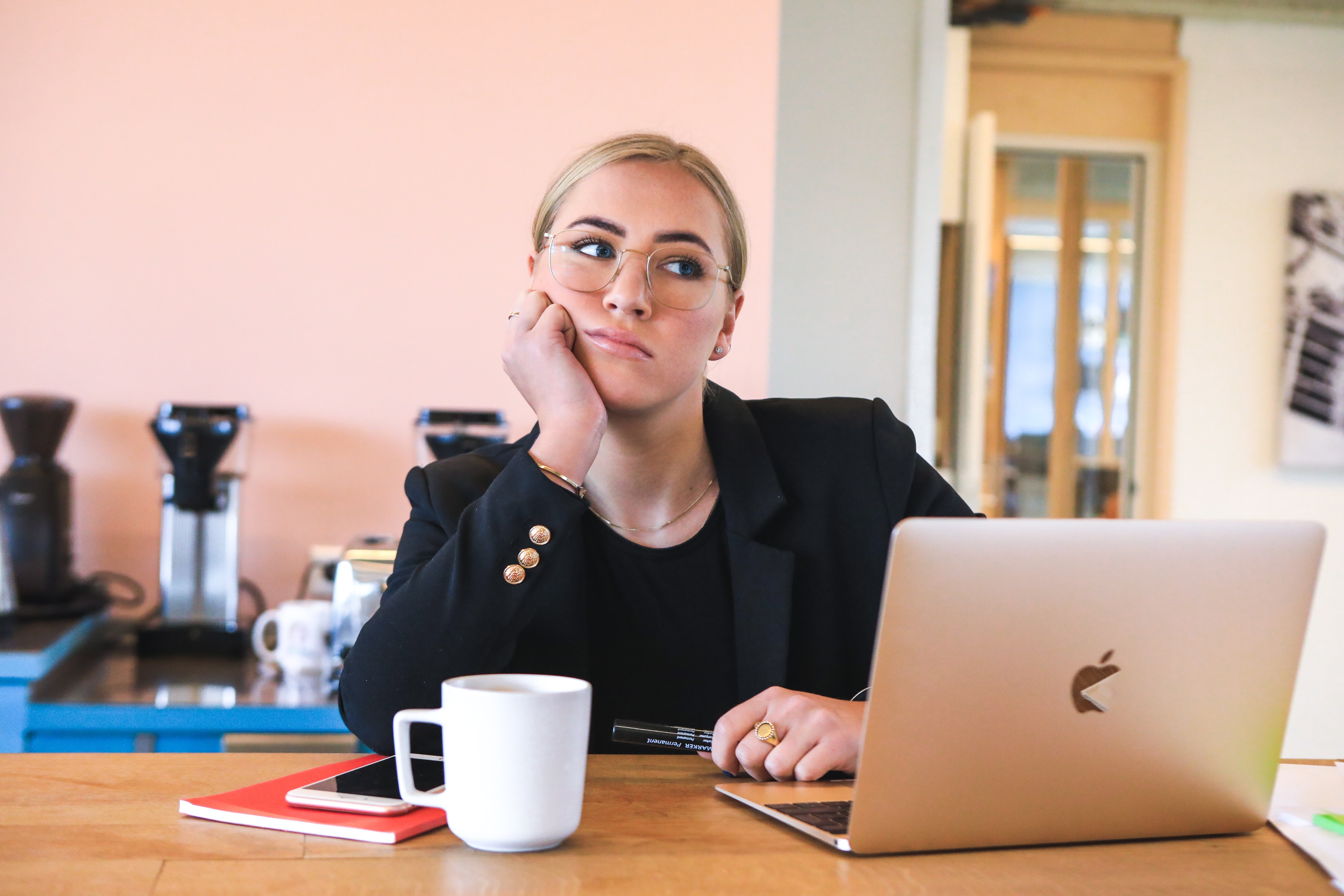 A student looking stumped at her laptop