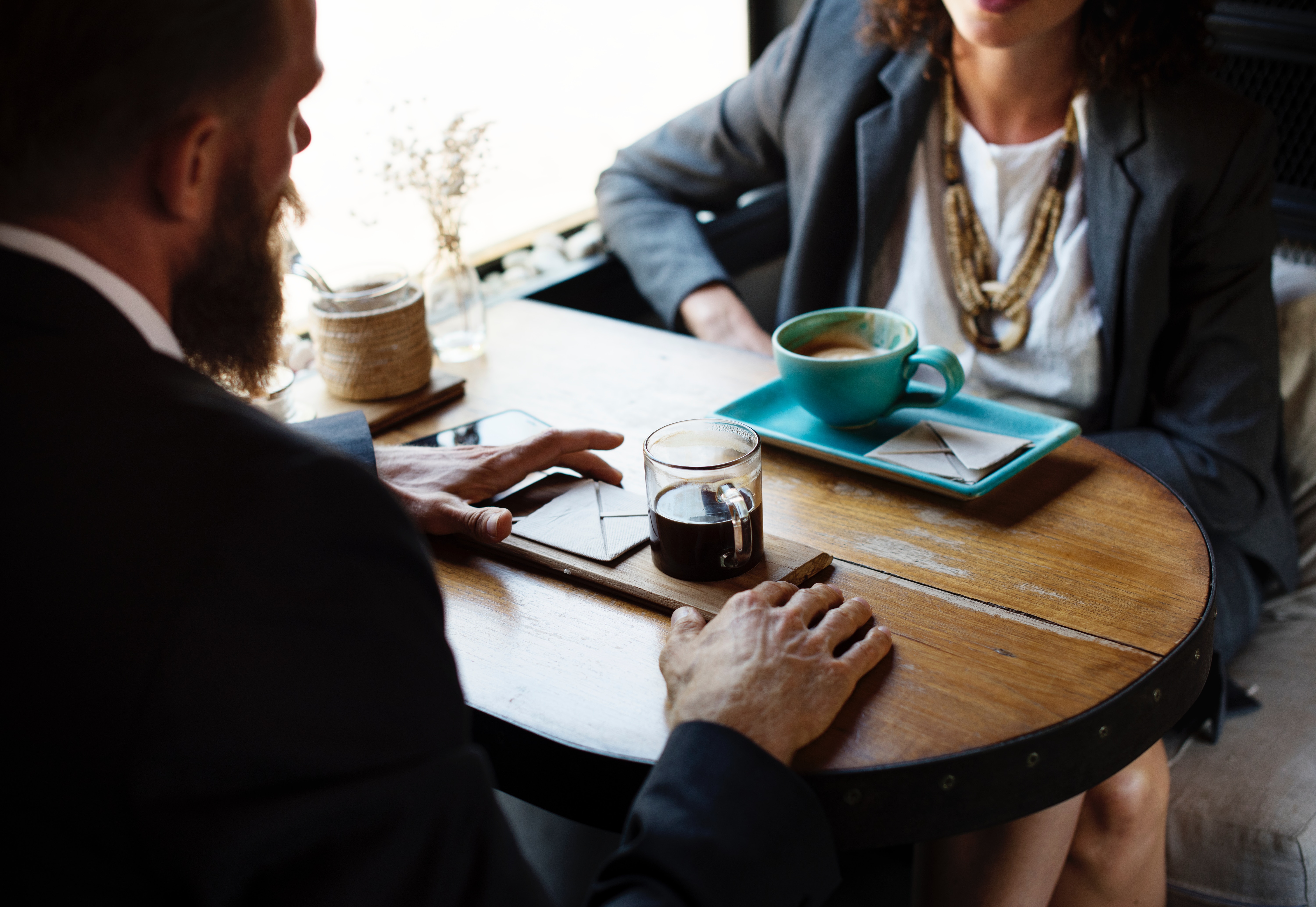 Two people talking at a table