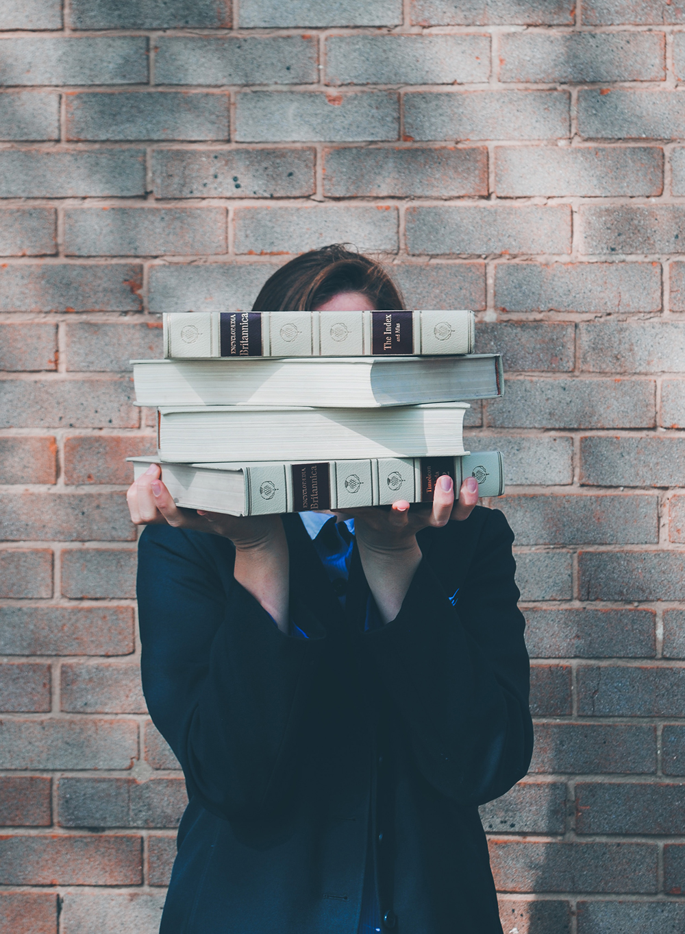 Woman holding up a magazine to her face