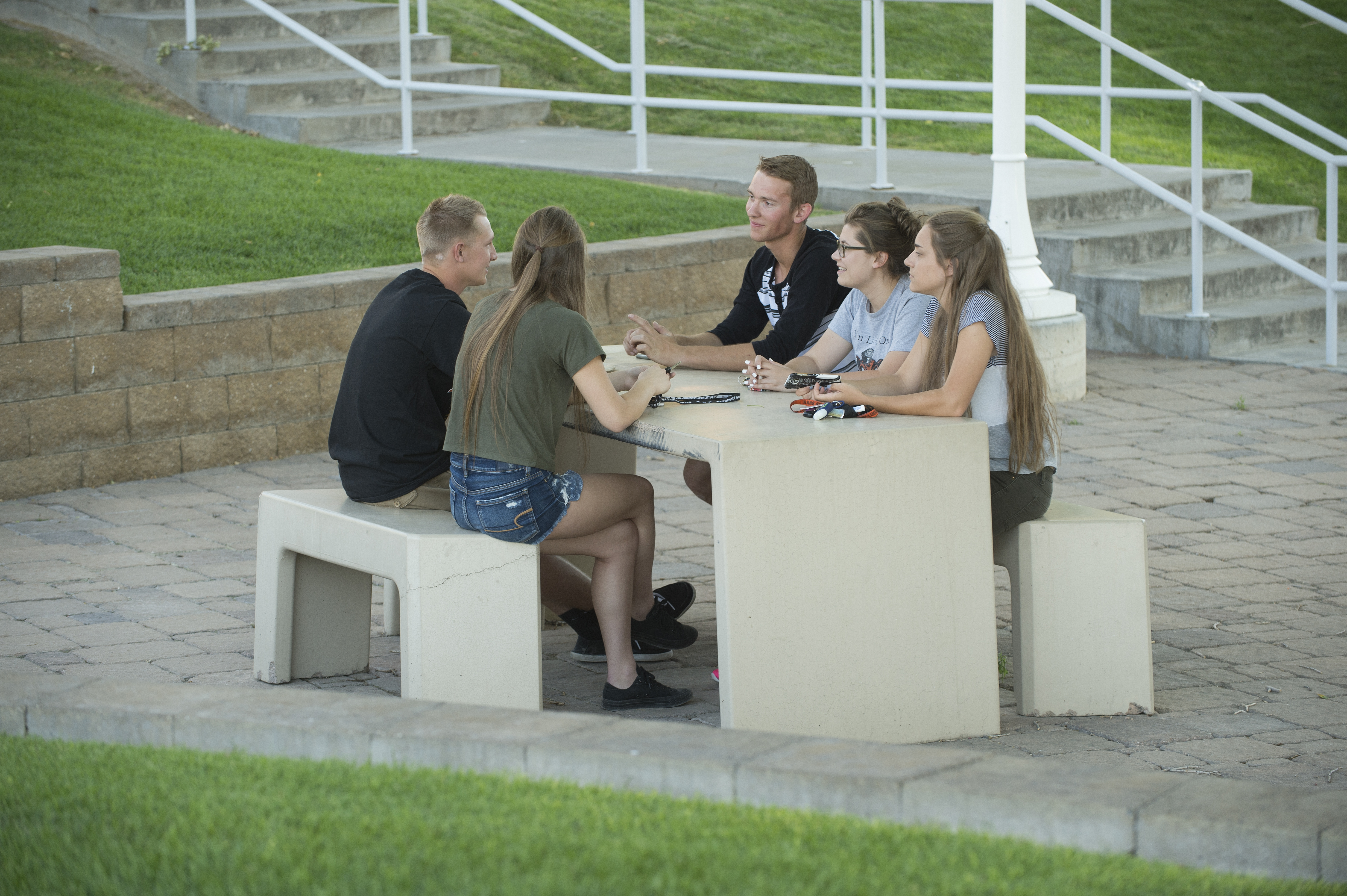 A group of students sitting outside and working on a project