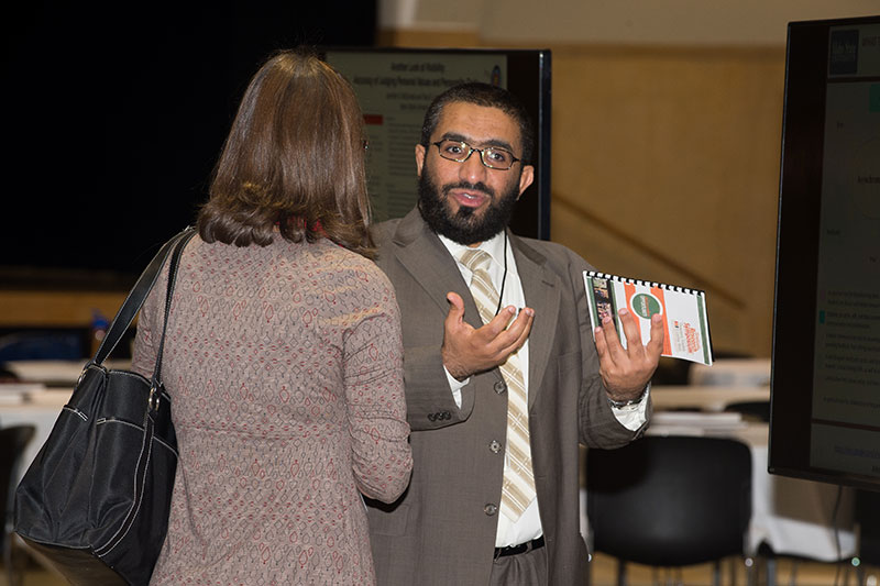 Student explaining research at the graduate research symposium