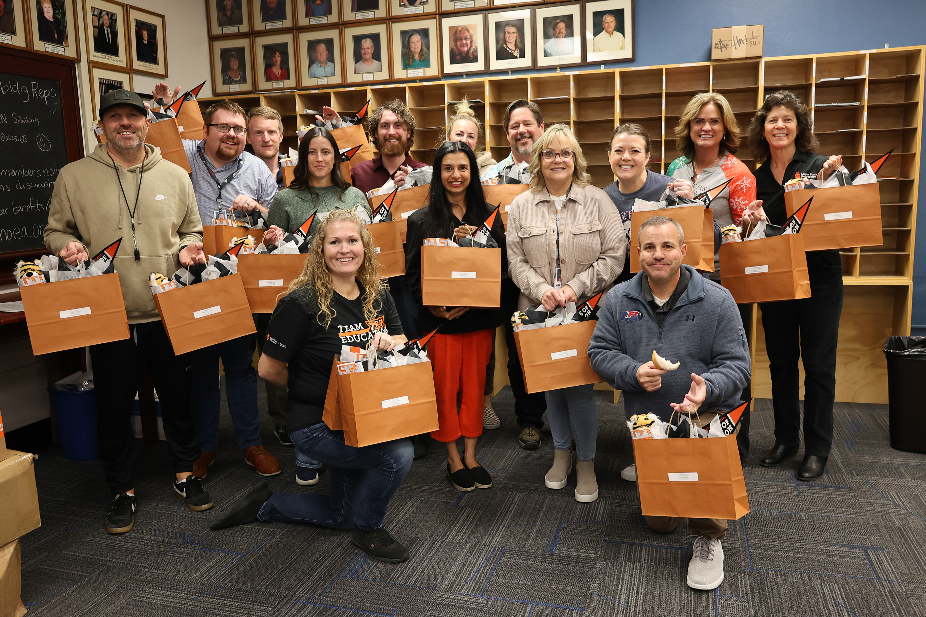 Group of faculty and staff with gift bags full of swag