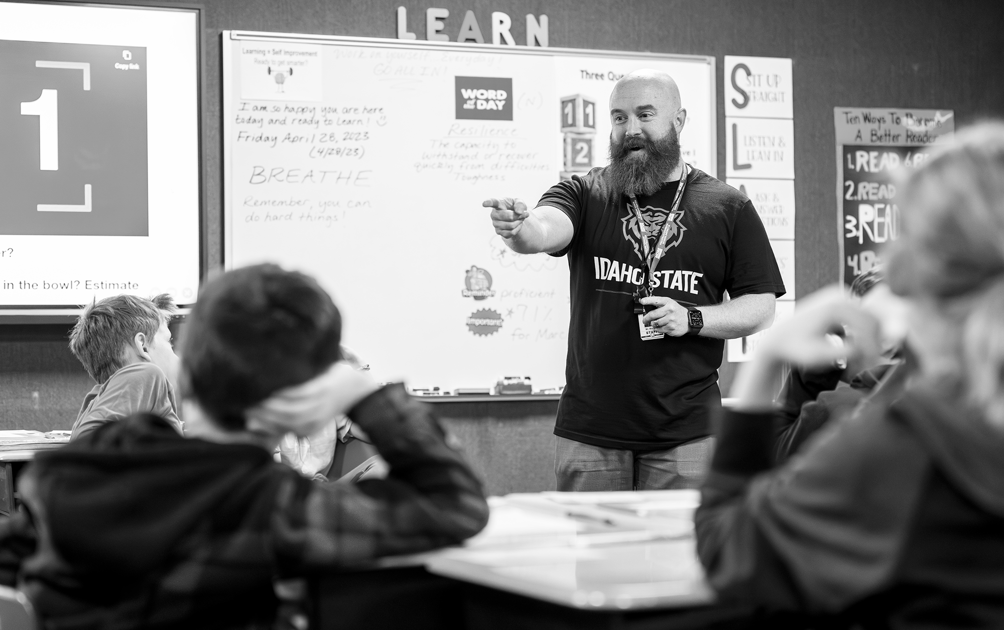 Idaho State University College of Education graduate student in the elementary education program helps his elementary children learn math skills at a local school.