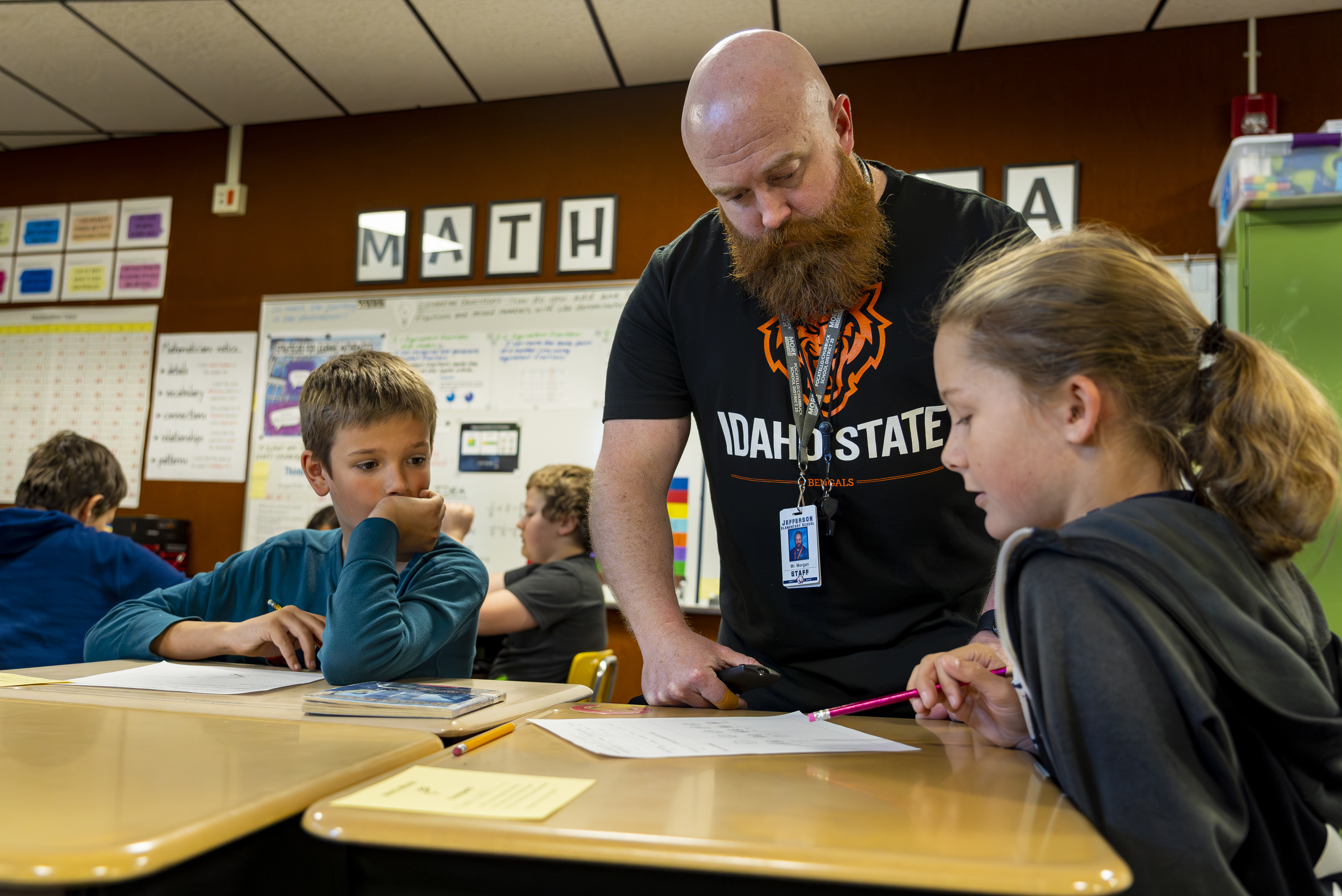 A math teacher instructs elementary students