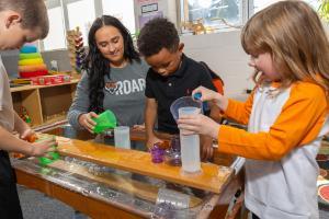 Idaho State University Early Childhood Education student works with young children teaching them knowledge and skills in a classroom.