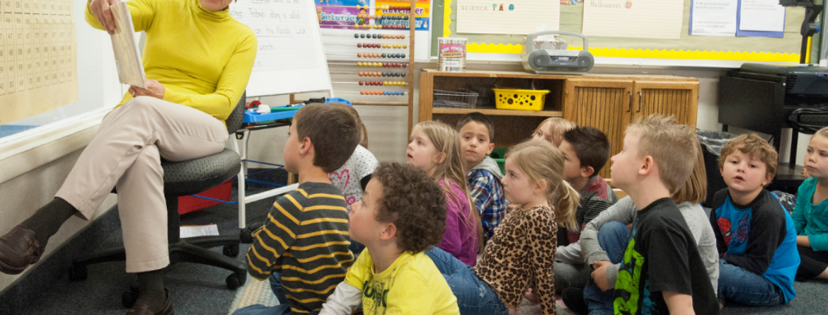 Woman reading to class of students