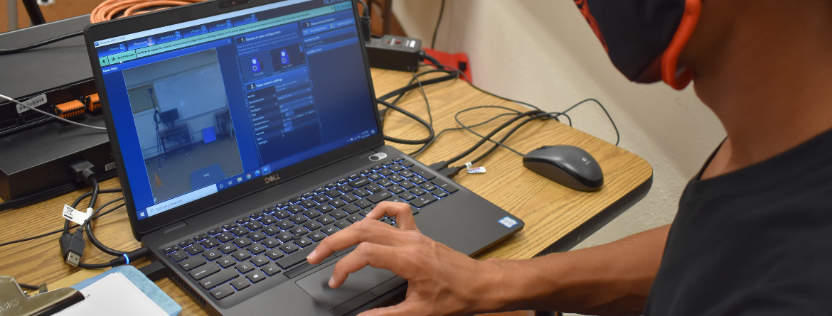 student working on computer in biomechanics lab