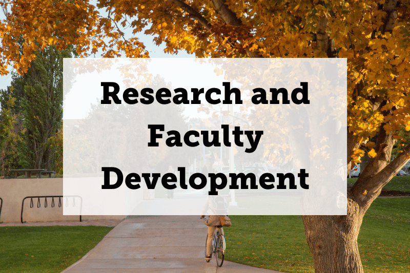 Text: Research and Faculty Development. Image: A sidewalk with grass and trees on both sides. The trees have leaves that indicate the time of the year as fall.