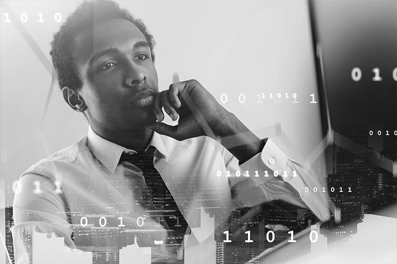Young black man studying computer data
