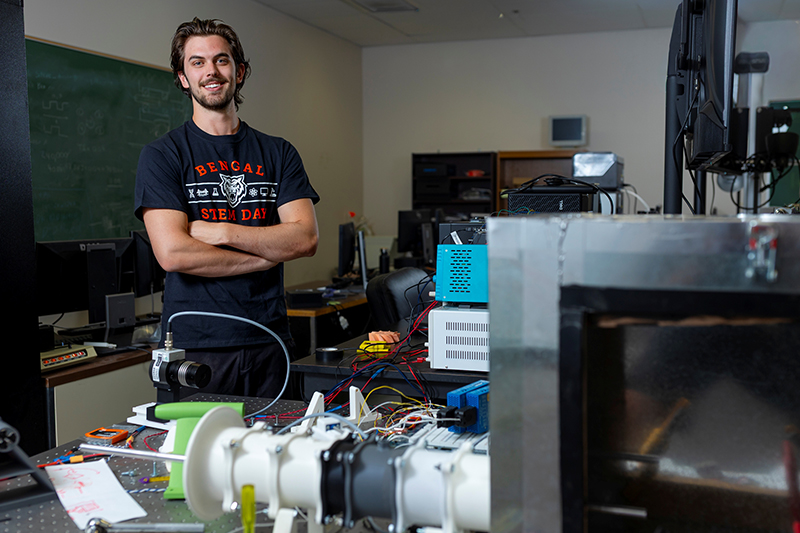 Christian Done poses for a photo in a lab at the Measurement & Control Engineering Research Center on Idaho State University’s Pocatello campus.