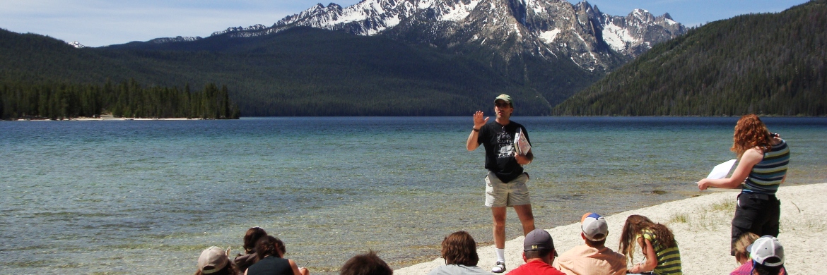 Glenn teaching students in front of a lake 
