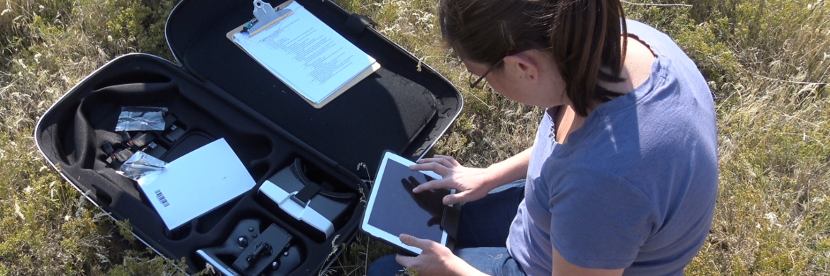 Geotech student in the field setting up her equipment