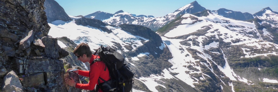 Student studying a geologic outcrop in the mountains