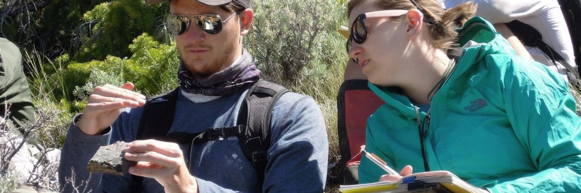 Students studying rocks in the field