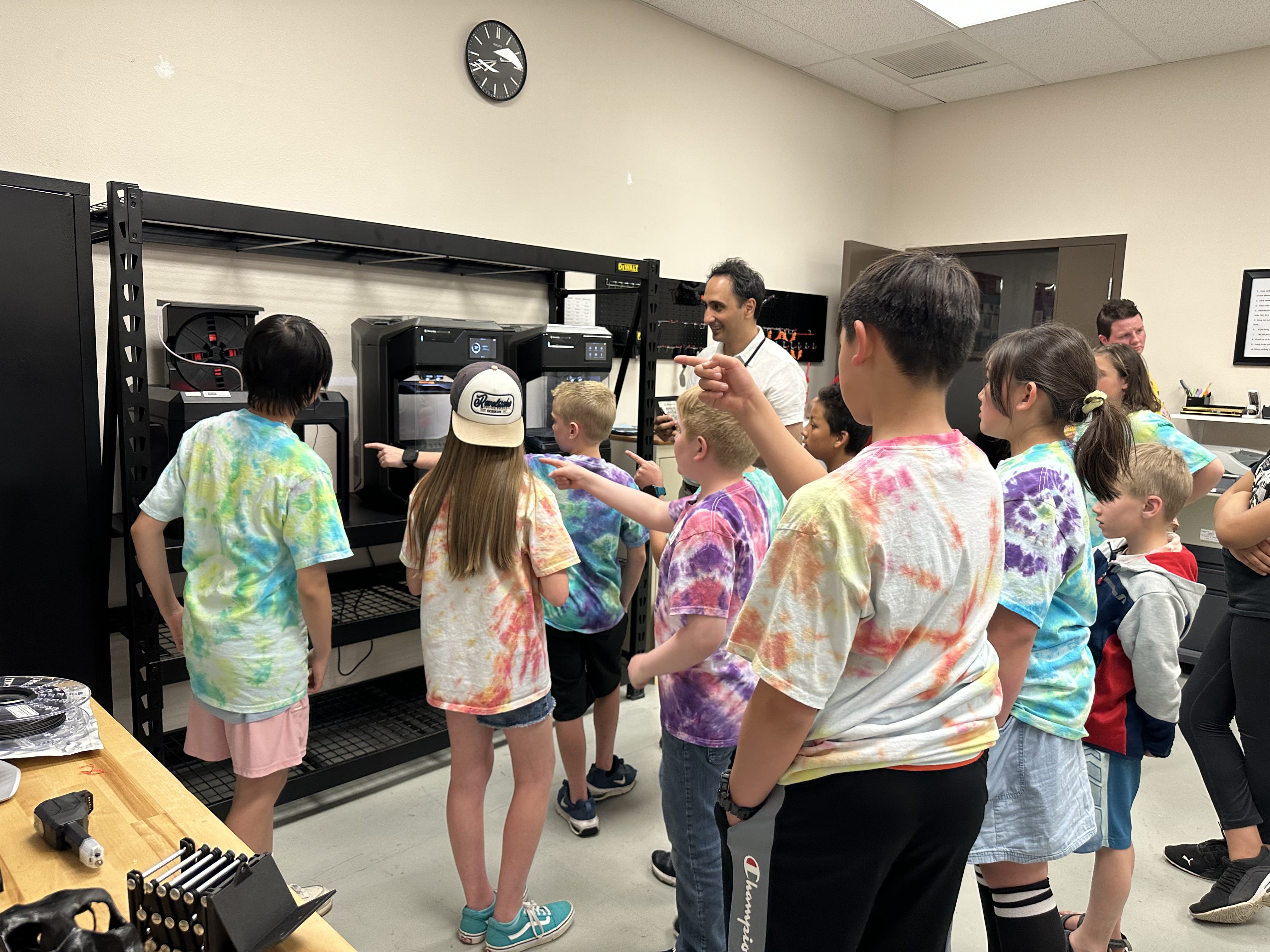 A group of visiting kids looking at 3D printers