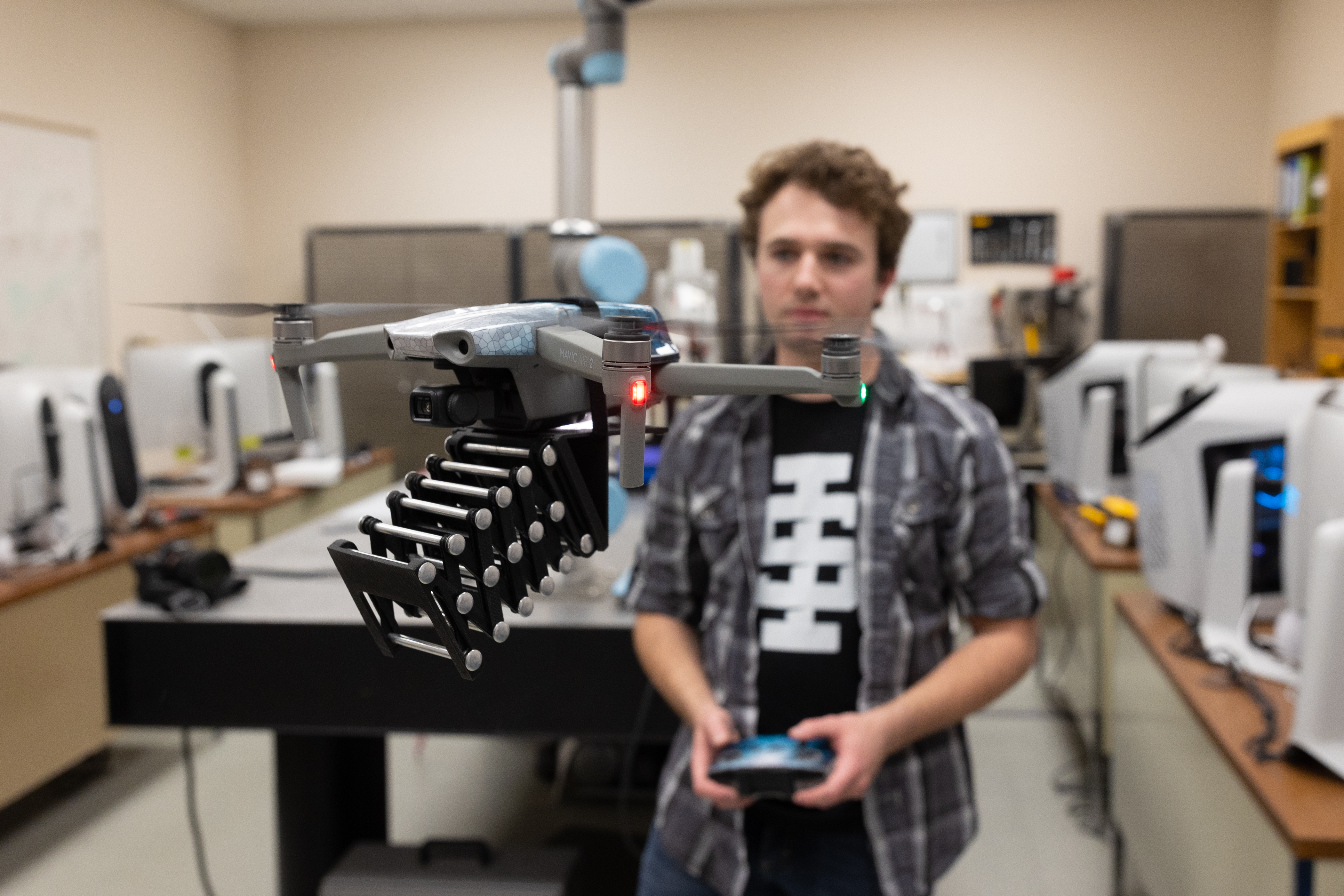 A student flying a robotic drone