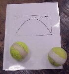 2 tennis balls and a piece of paper with a parabola on it