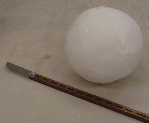 A ball and a knife sitting next to one another