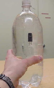 An object in a bottle of water at the bottom
