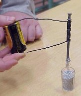 A battery connected to a nail via wires