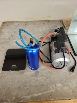Vaccuum Pump next to a bottle of air and a scale.