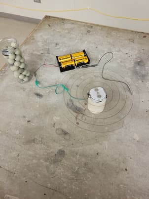 A circular contraption that spins connected to a battery source