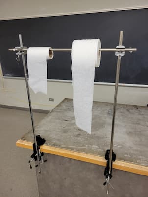 A small and big toilet paper roll on steel bars