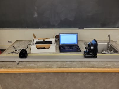 A fan cart set up on a pasco track with software visible and a motion detector