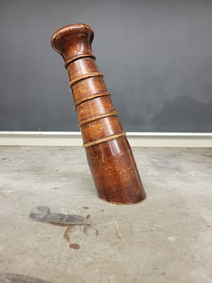A chunk of wood that looks like a tower leaning