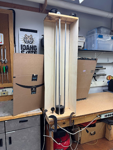 Pile Driver placed on demo table with clamps holding it firm on the table.
