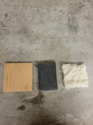 A square piece of lead, wool, and wood