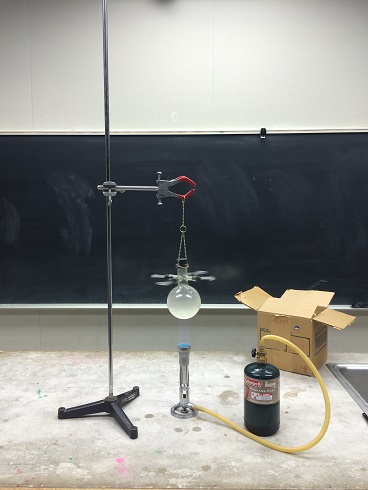 A flask over a Bunsen burner spinning