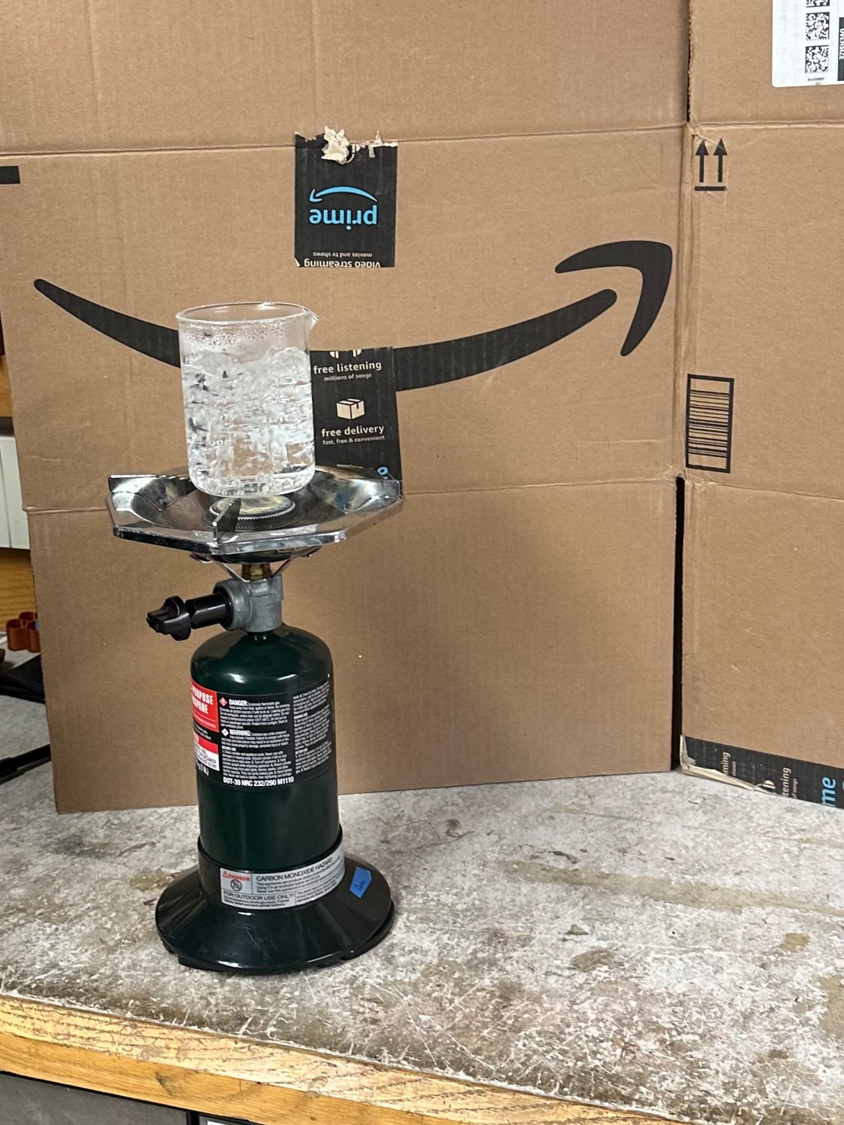 A beaker of boiling water on a propane stove