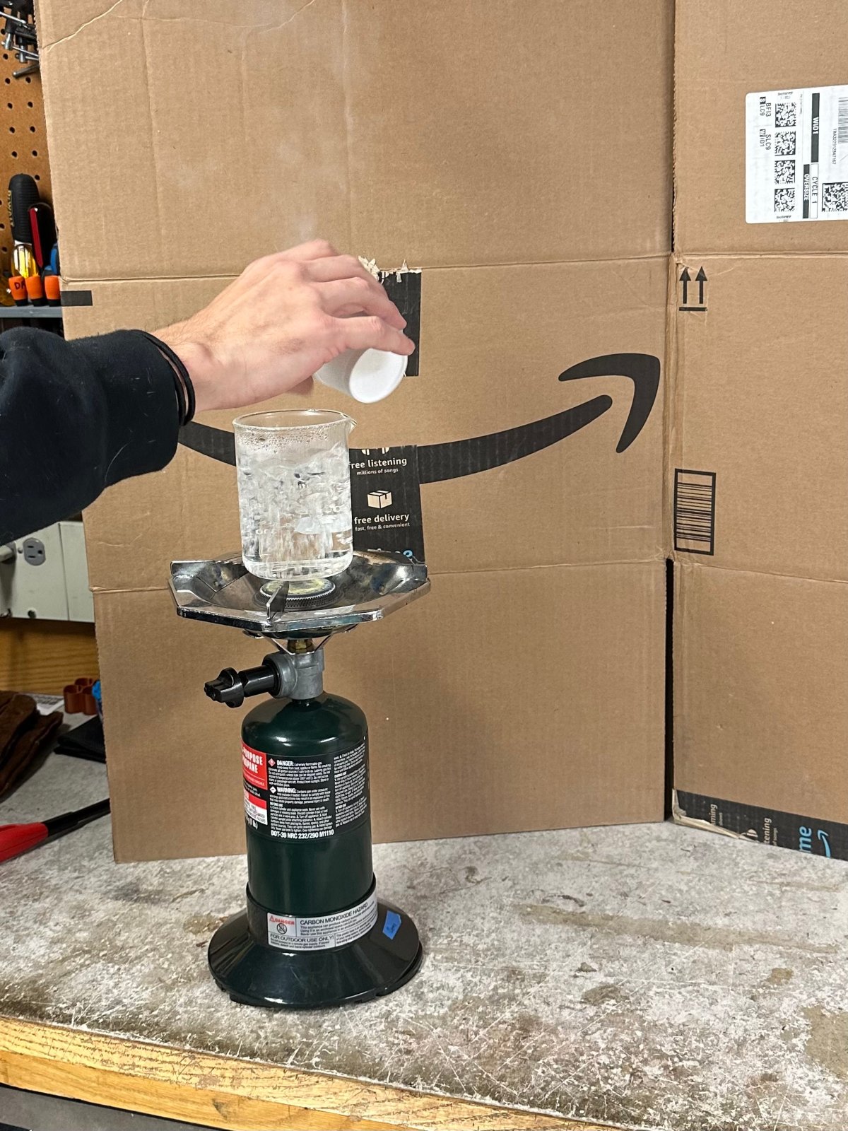 Someone pouring liquid nitrogen into boiling water
