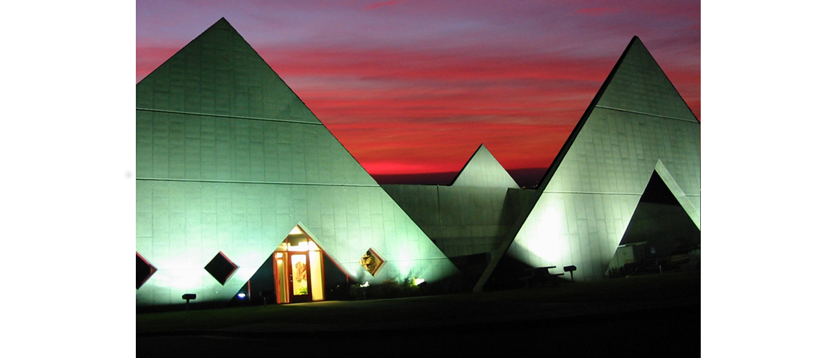 The Idaho Accelerator Center at sunset, the front is lit up with clouds in the background