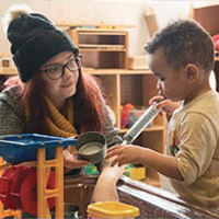 Early Childhood Care and Education student working with a child