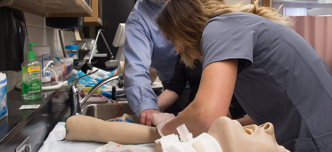 Respiratory Therapy students working in lab on a SimMan